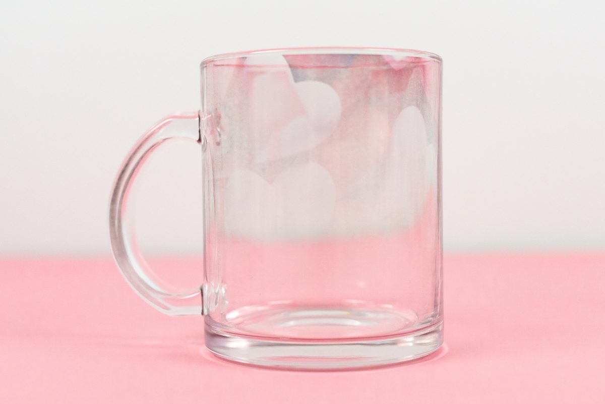 Glass mug with very faded heart design
