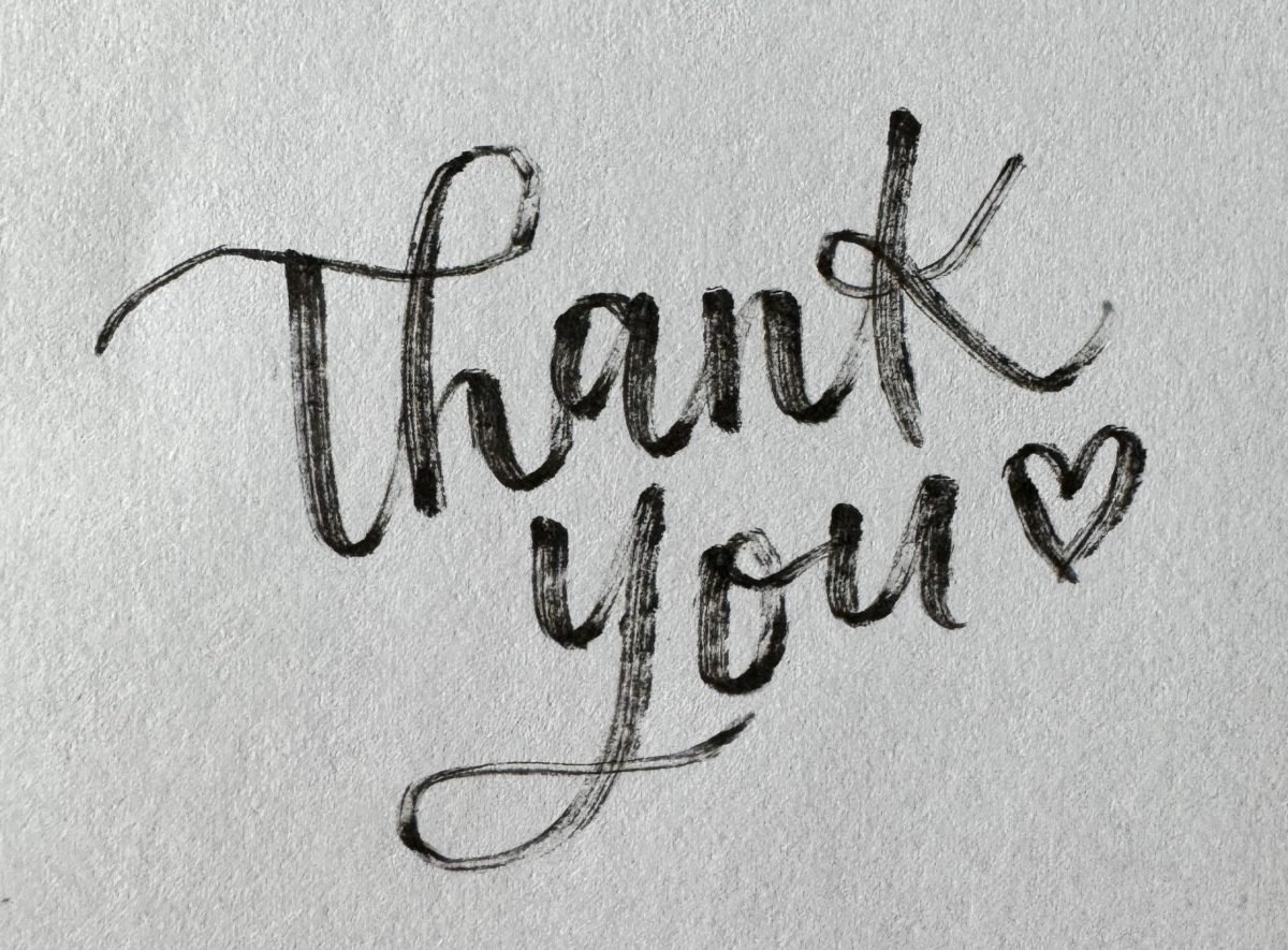 Hand-lettered "thank you" in a brush pen