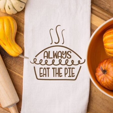 White kitchen towel with image of a pie and the words Always Eat the Pie on it