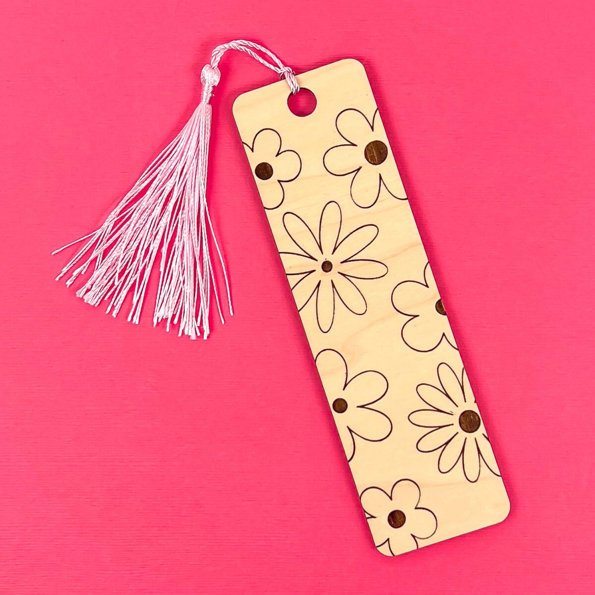 Wood flower bookmark on pink background
