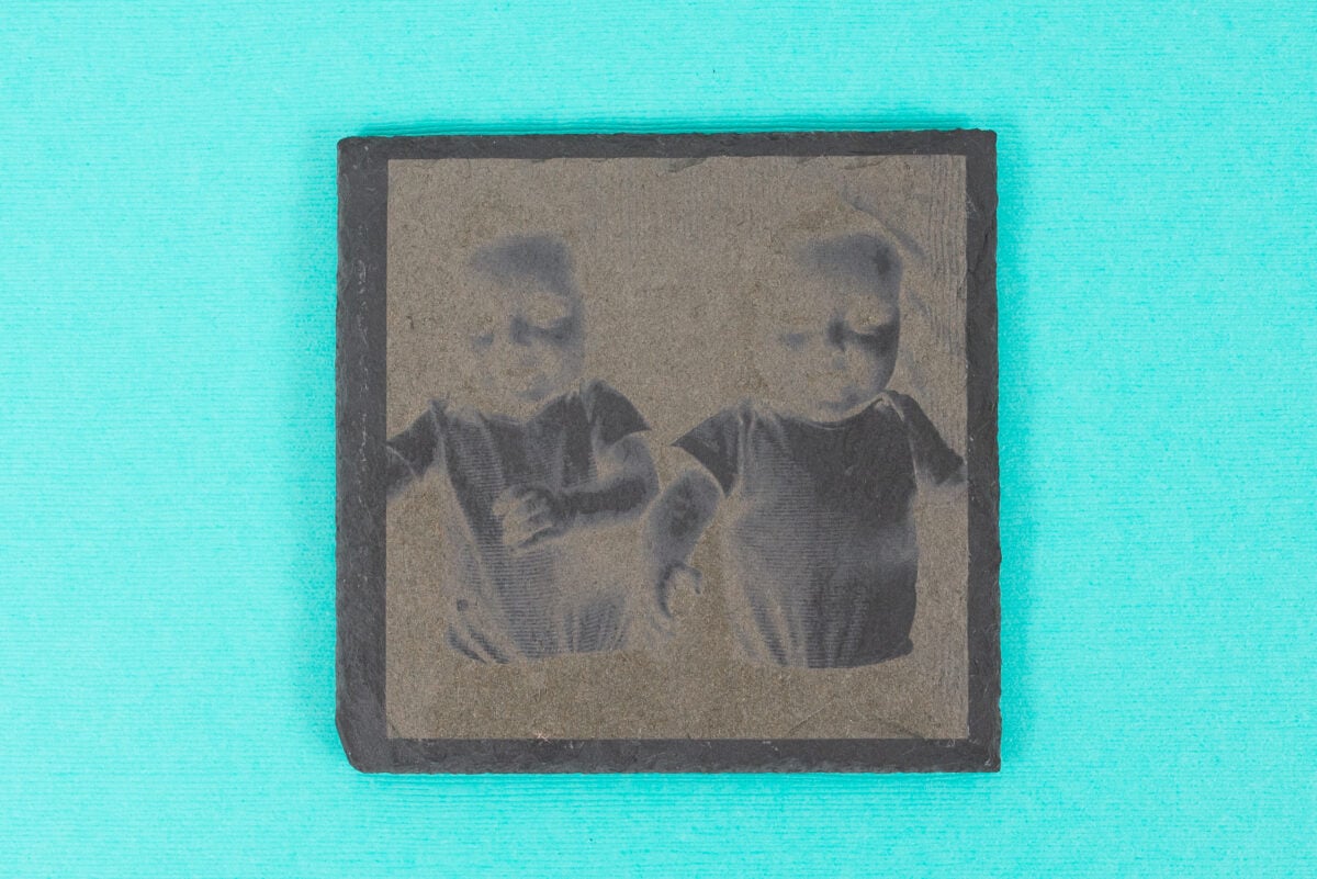 Engraved slate with image of babies inverted