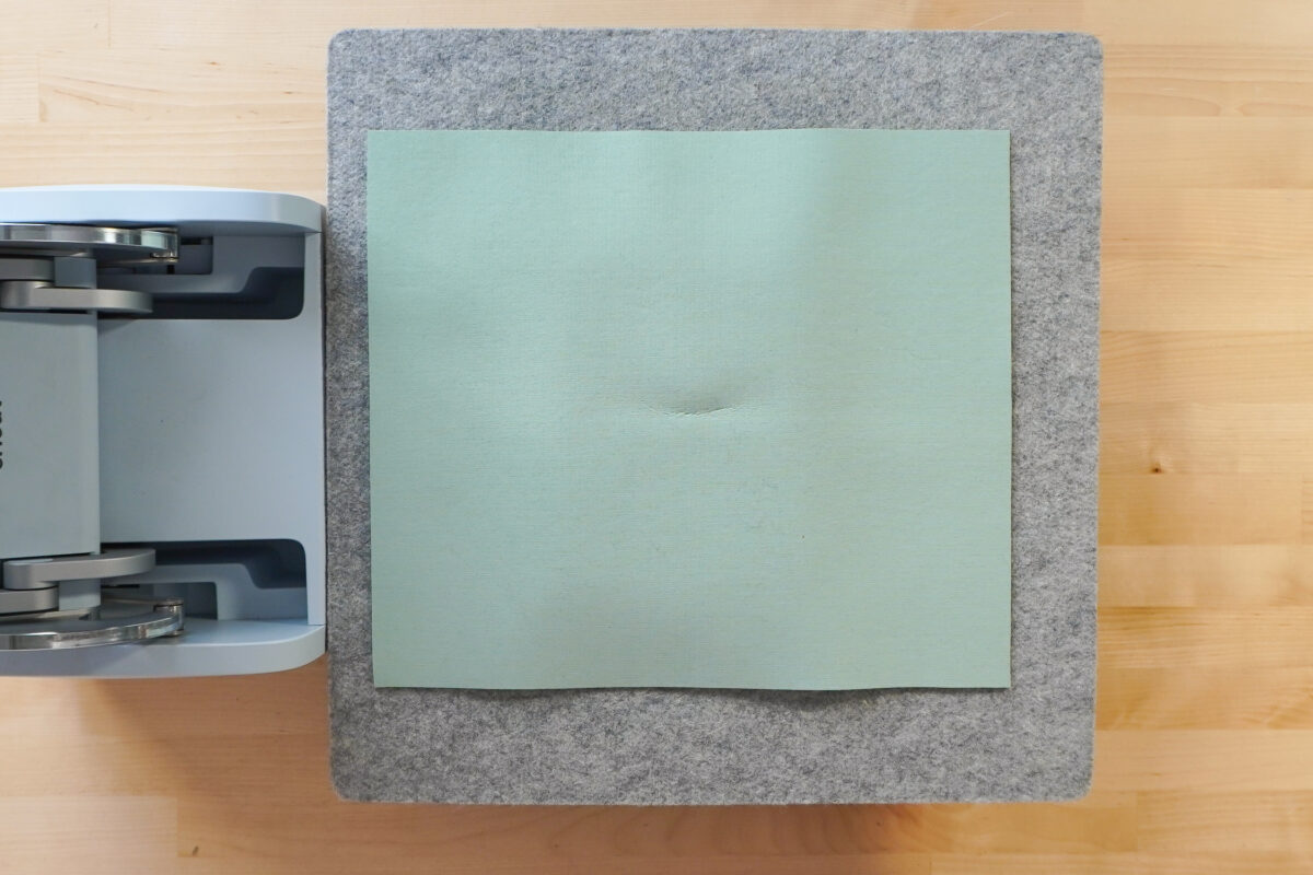 Cricut AutoPress with wool mat, piece of butcher paper, slate, print, butcher paper, green mat