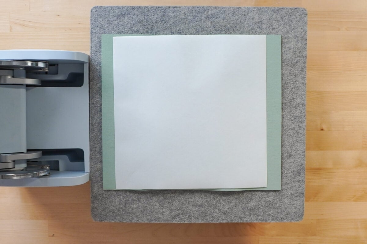 Cricut AutoPress with wool mat, piece of butcher paper, slate, print, butcher paper, green mat, butcher paper