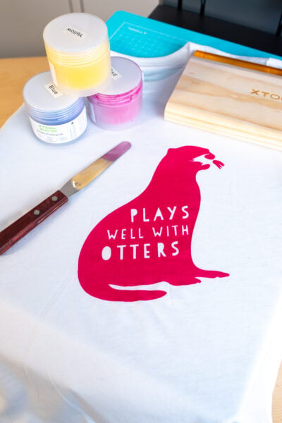 xTool Screen Printer with Plays Well with Otters shirt and screen printing supplies