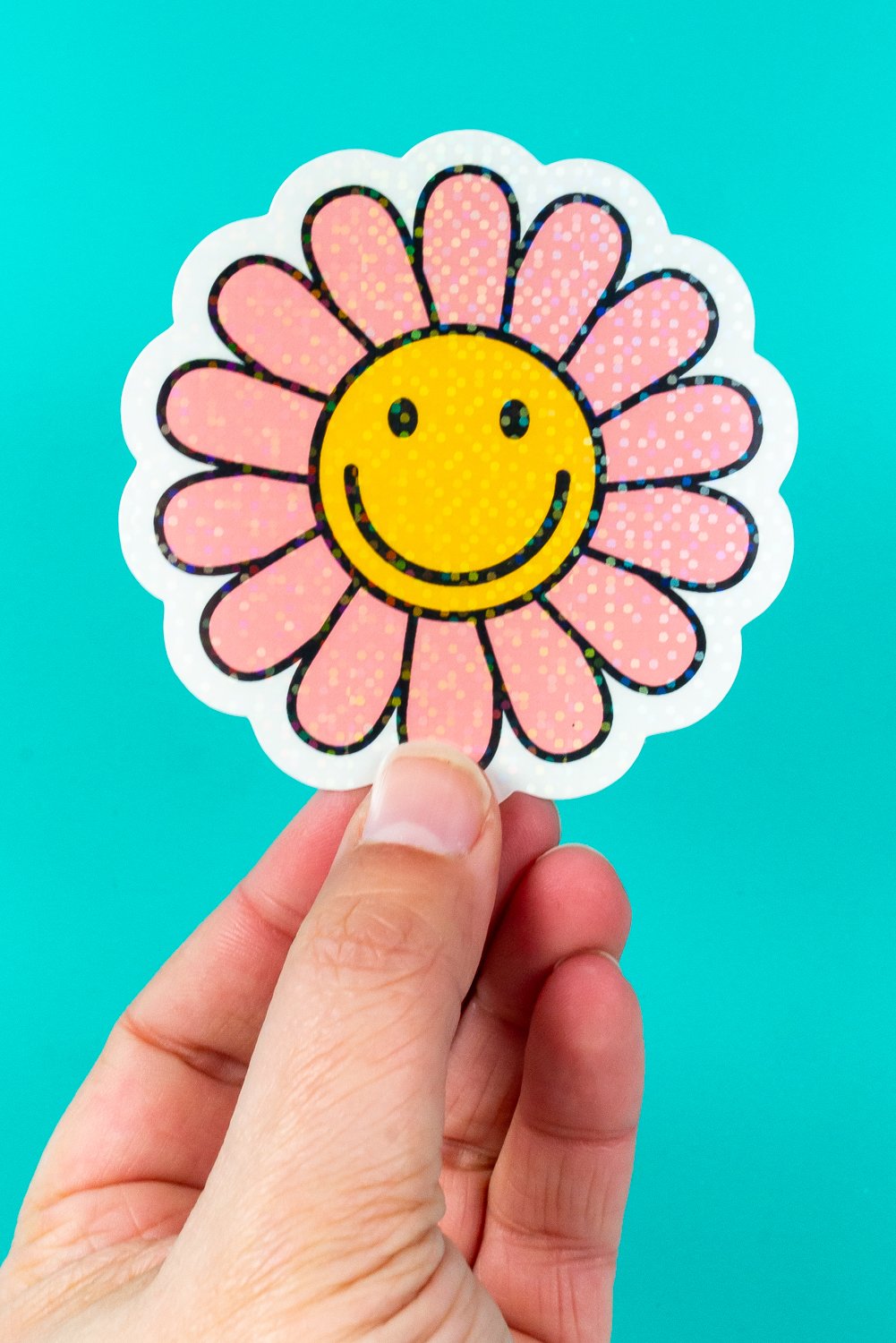 Hand holding flower sticker