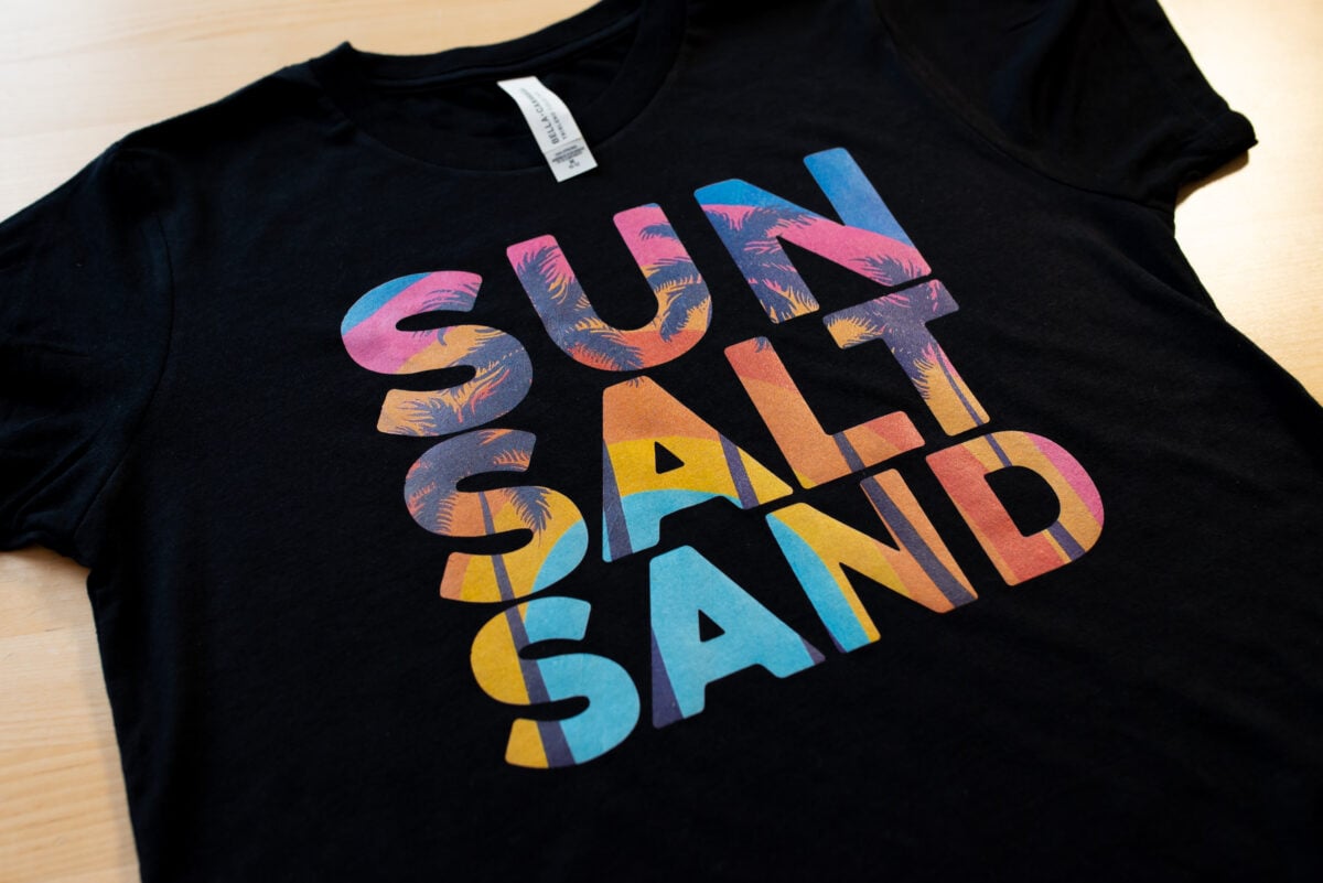 Black shirt with SUN SALT SAND image on it