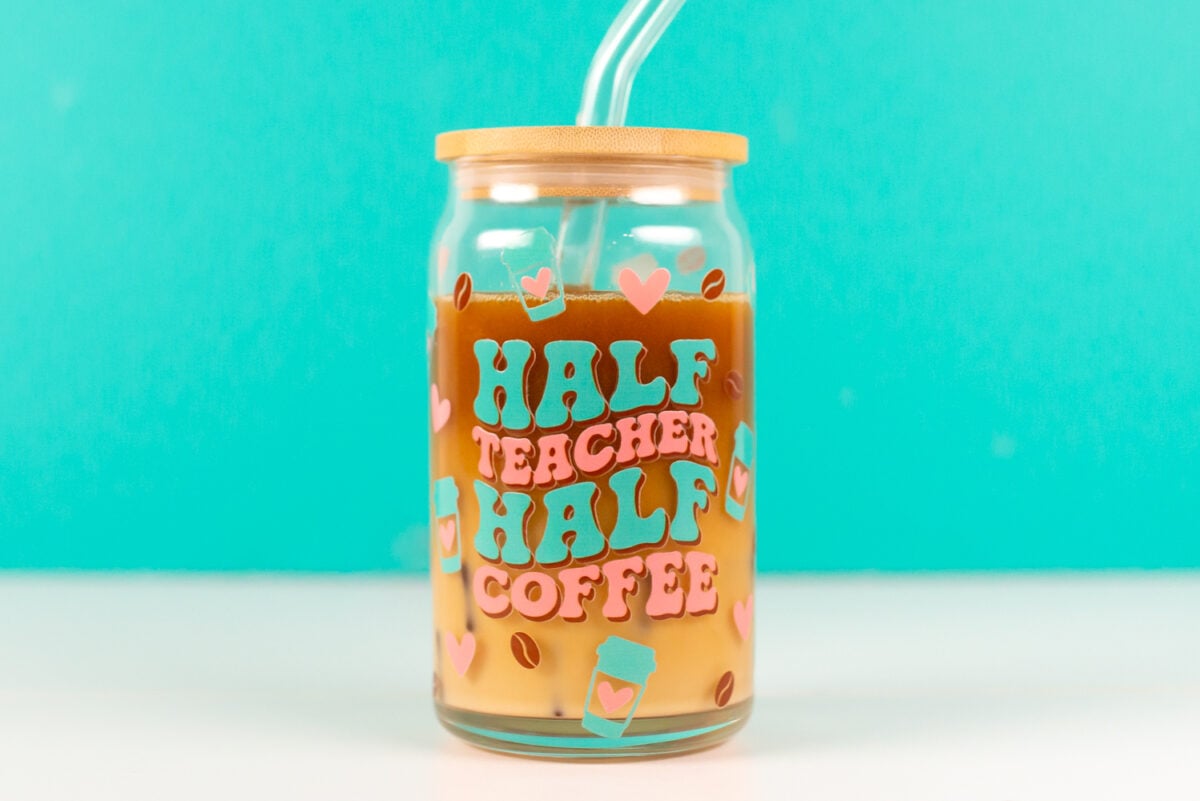 Half Teacher / Half Coffee glass can with iced coffee inside.