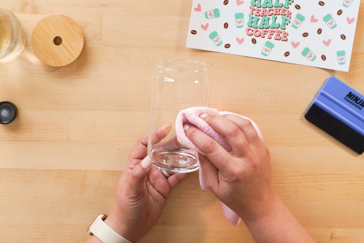 Cleaning a glass cup with alcohol