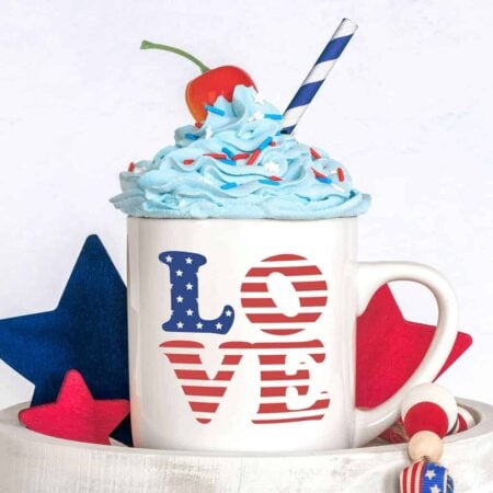 A white mug with the word Love in patriotic colors of red, white and blu