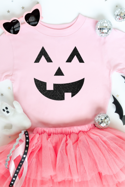 Pink t-shirt with black glitter jack-o-lantern transfer