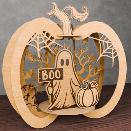 Wooden pumpkin design that includes a ghost holding a "boo" sign, trees and spider webs