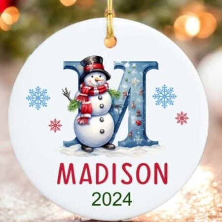 A Christmas ornament with an initial M on it and the name Madison.