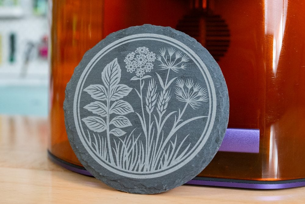 Engraved slate coaster with wildflower design