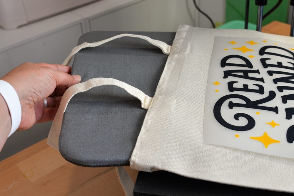 Hand putting a pad inside a bag before pressing