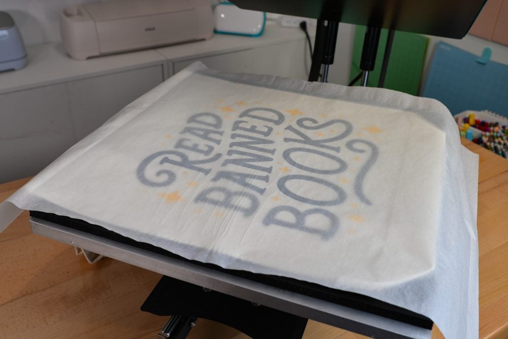 Bag and transfer in heat press with parchment paper on top