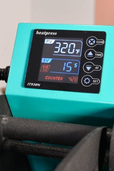 Heat press control box showing 320 degrees and 15 seconds