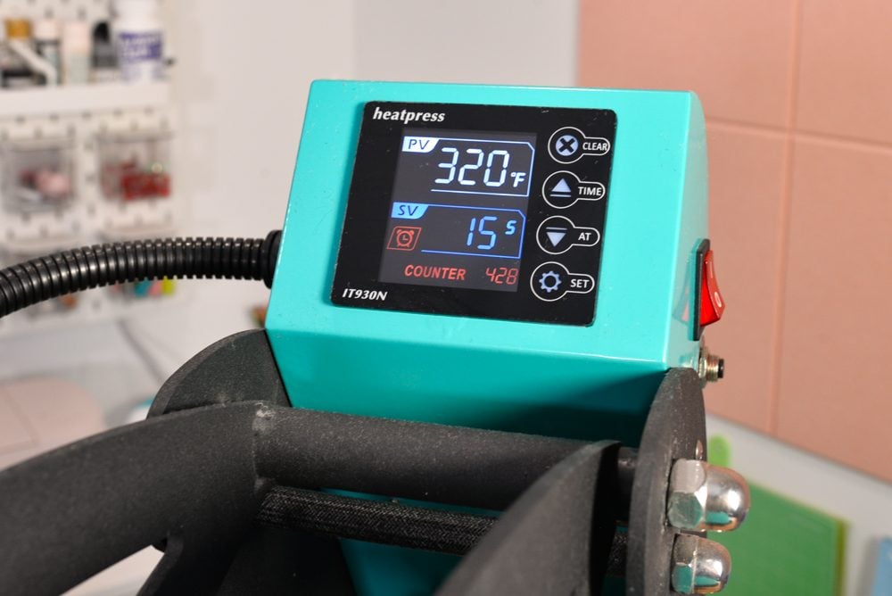 Heat press control box showing 320 degrees and 15 seconds