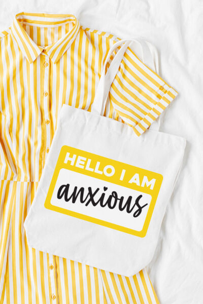 Hello I Am Anxious SVG on white tote with yellow and white striped dress