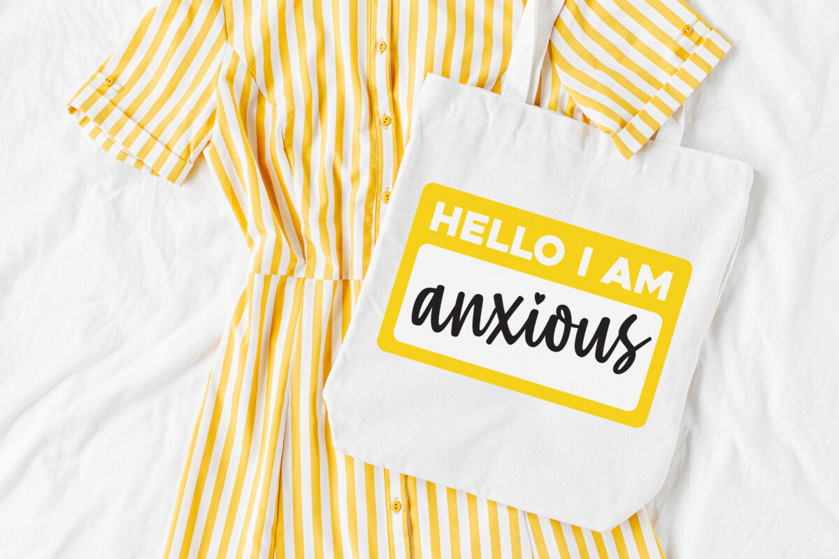 Hello I Am Anxious SVG on white tote with yellow and white striped dress