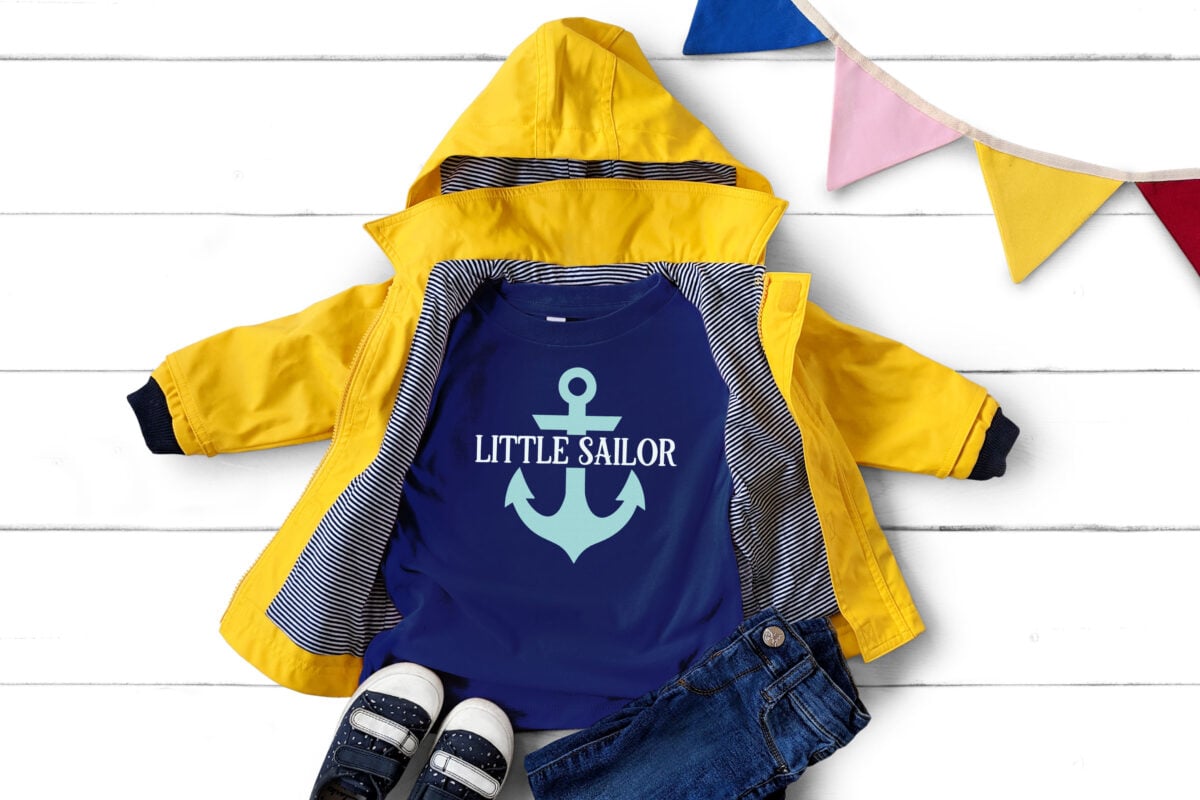 Little Sailor SVG on a dark blue shirt with a yellow rain coat