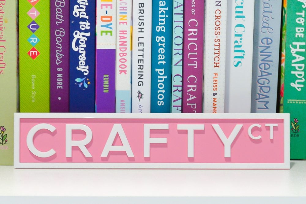 Crafty Ct street sign on a bookshelf with crafty books