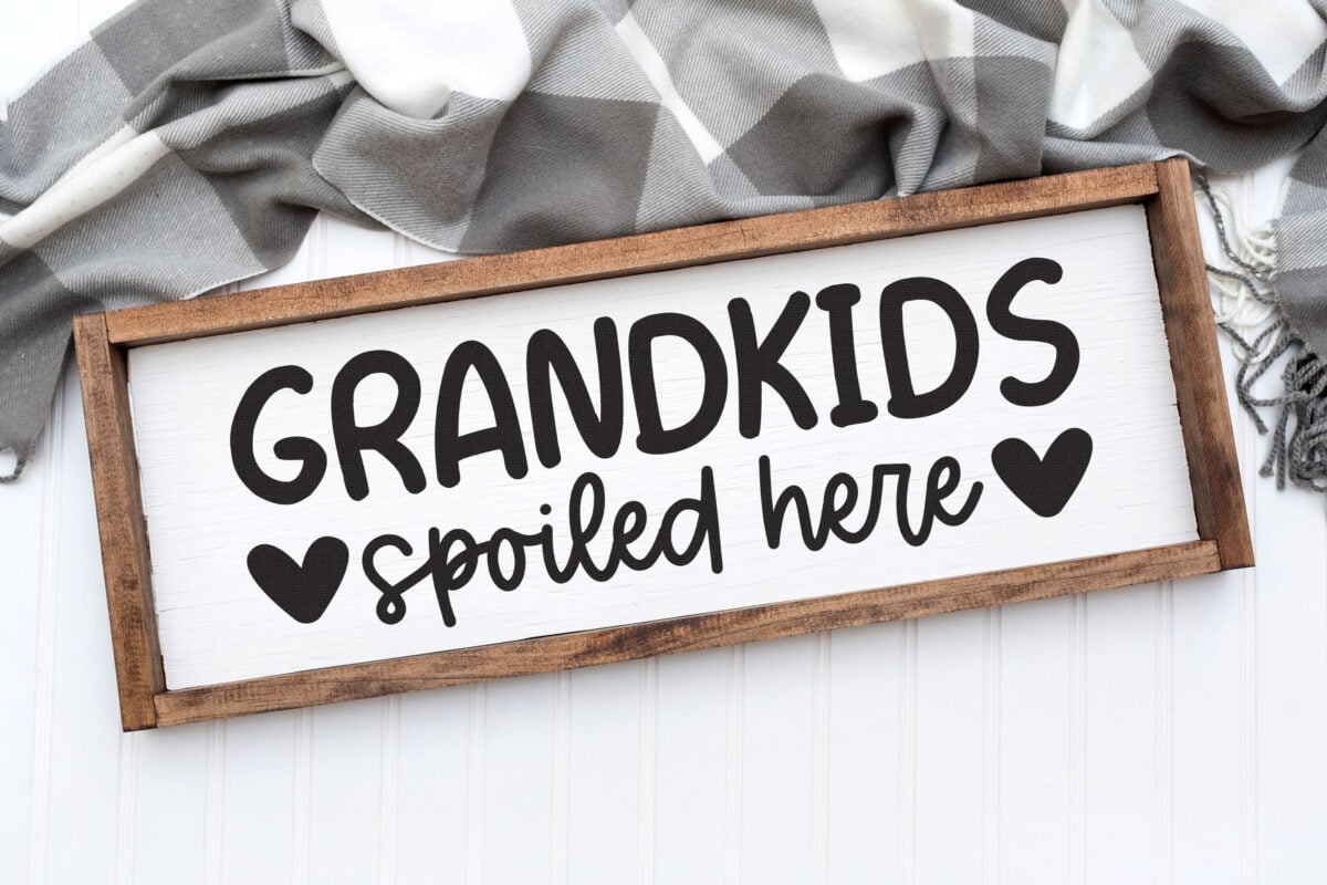 Free Grandkids SVG on a sign with a scarf behind it