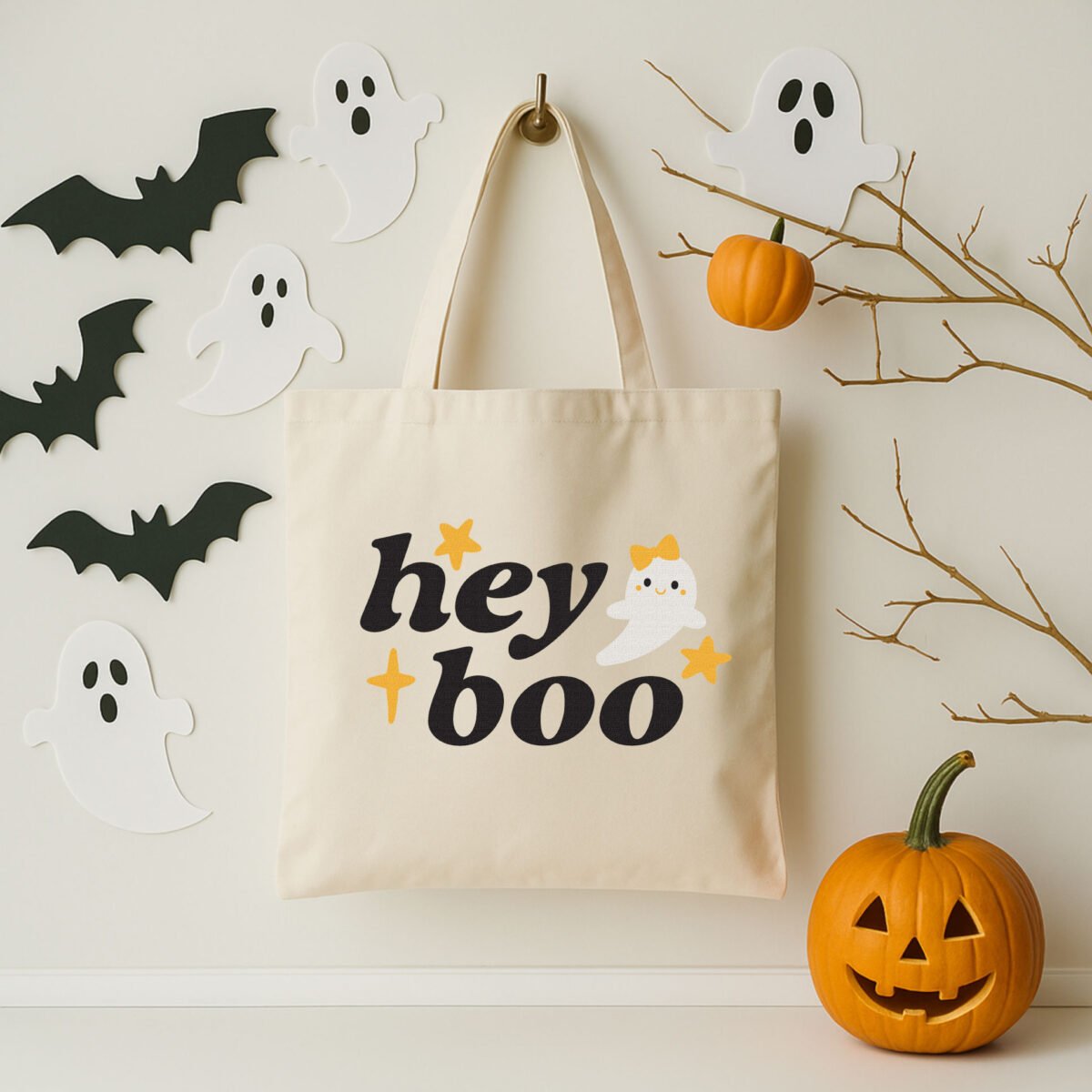 Hey boo ghost SVG on a canvas tote with halloween decor