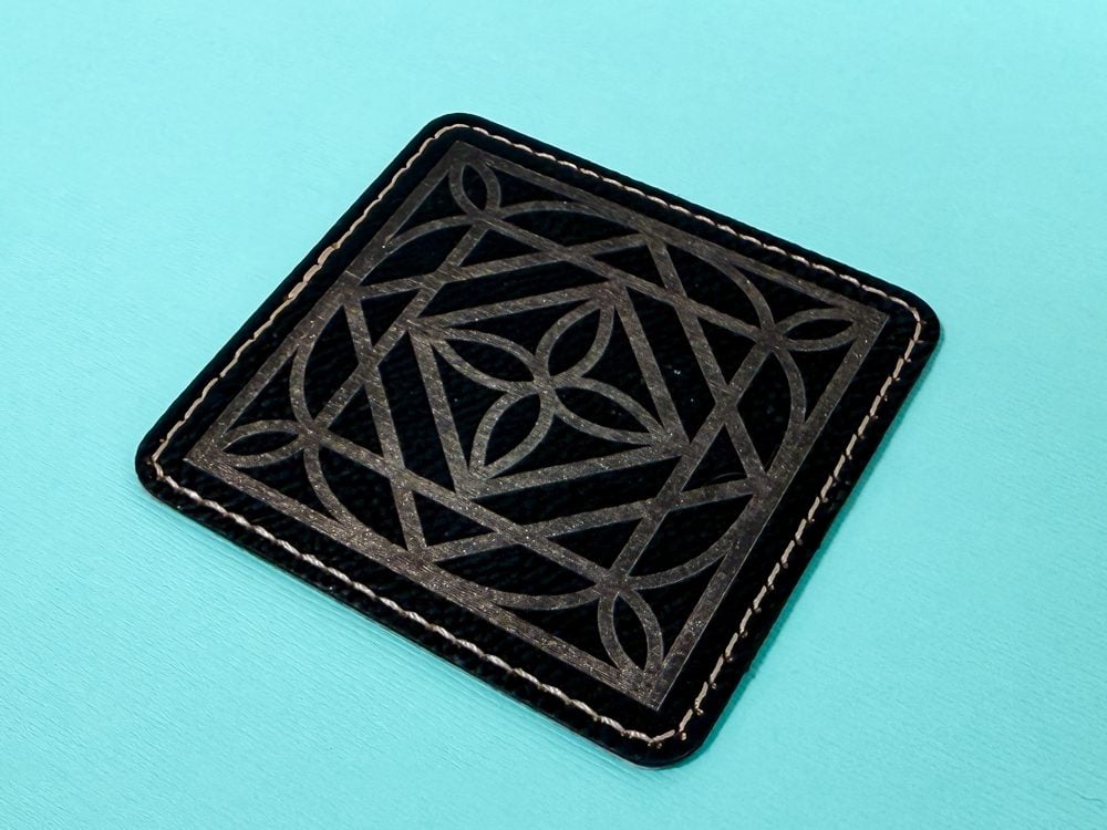 Engraved leather patch on a blue background