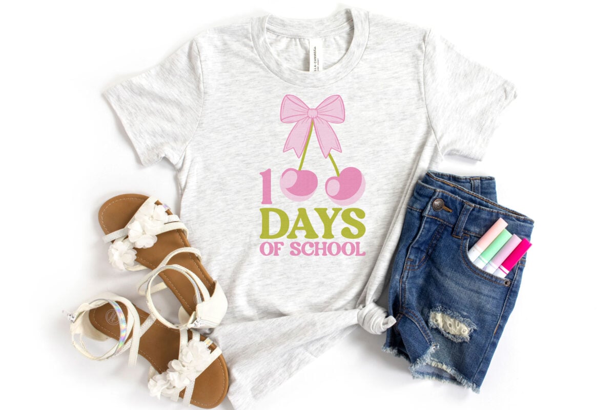 100 Days of School Cherry Sublimation File on a light gray kid's shirt with sandals and shorts with pens in the pocket