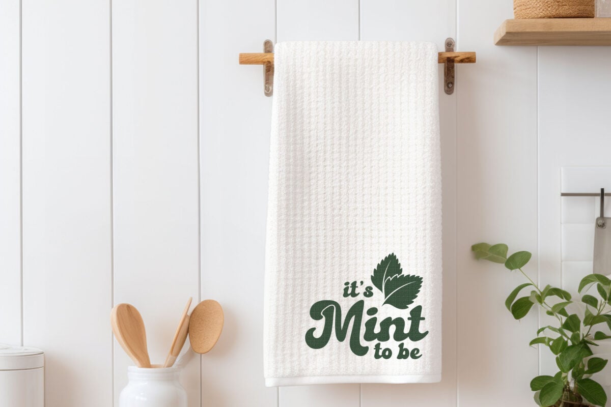 It's Mint to Be SVG pin image on a tea towel with kitchen accessories