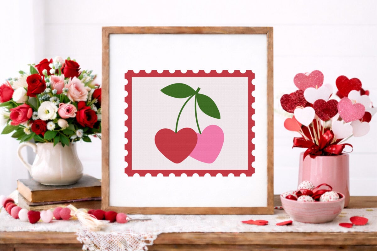 Valentine's Day Stamp SVG on a frame with pink and red accessories