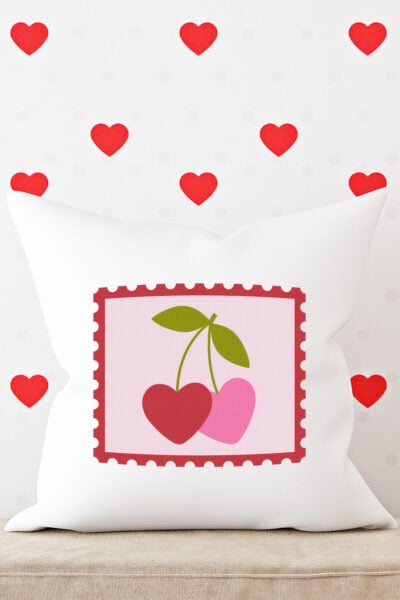 Valentine's Day Stamp SVG on a white pillow with red hearts