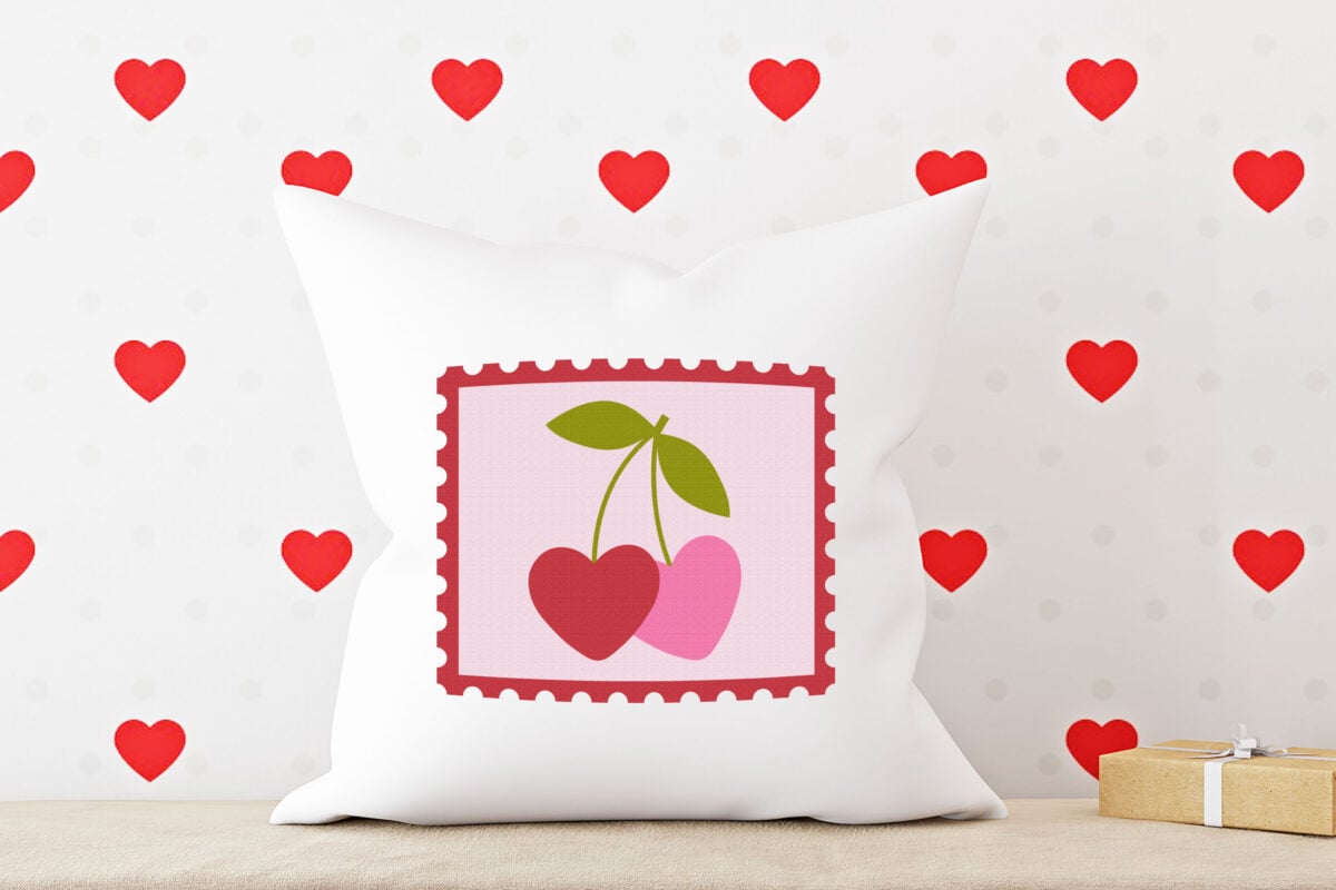 Valentine's Day Stamp SVG on a white pillow with red hearts