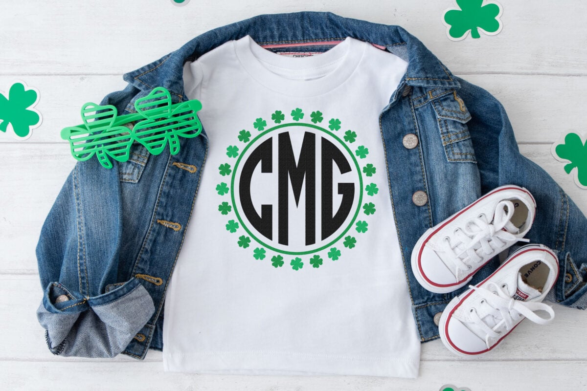St. Patrick's Day Monogram used on a white shirt with a jean jacket and paper shamrocks