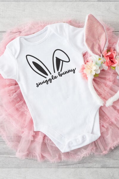Free snuggle bunny SVG on a white onesie with bunny ears and pink tutu