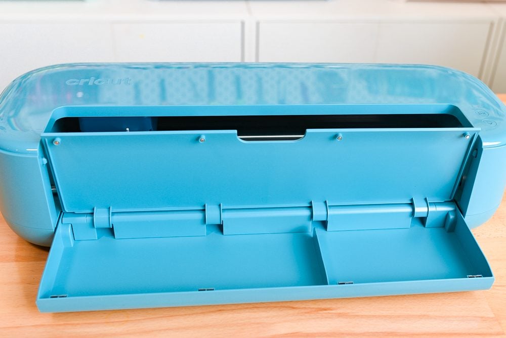 Cricut Explore 5 on a table, with the tool tray open.