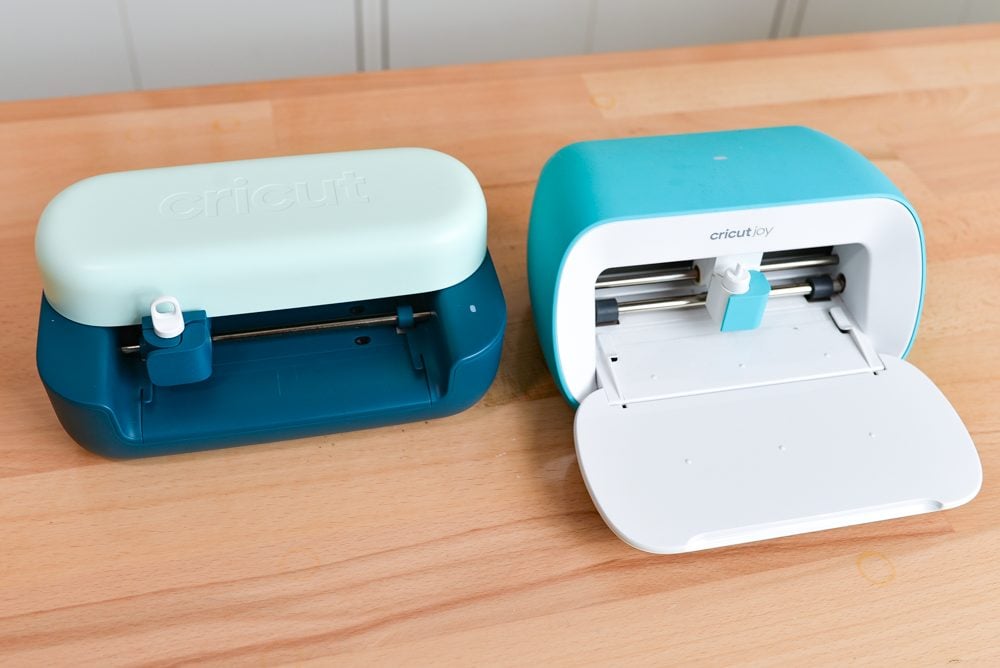 Cricut Joy 2 and Cricut Joy open on a table