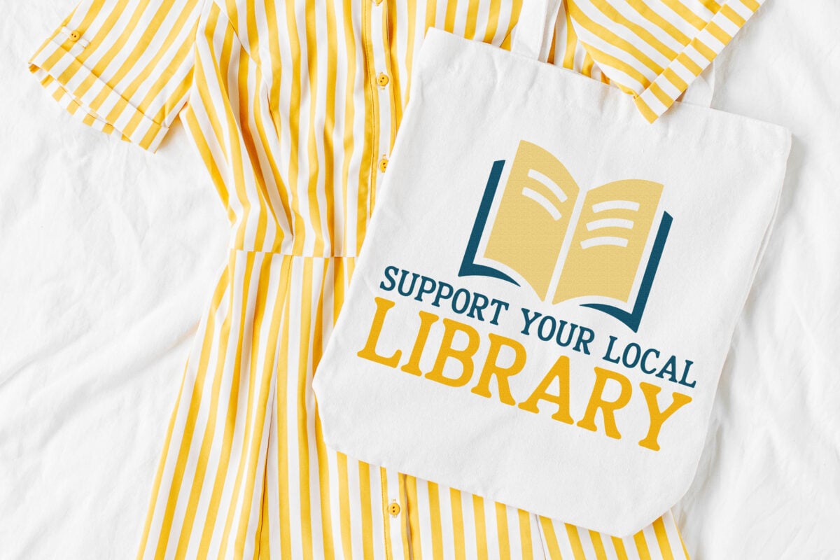Support Your Local Library SVG on a tote bag with a yellow dress