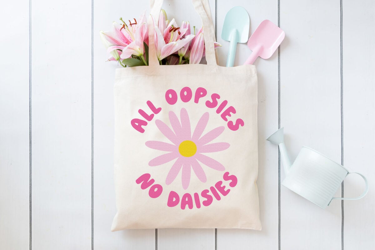 Free Daisy SVG on a tote bag with cute gardening supplies
